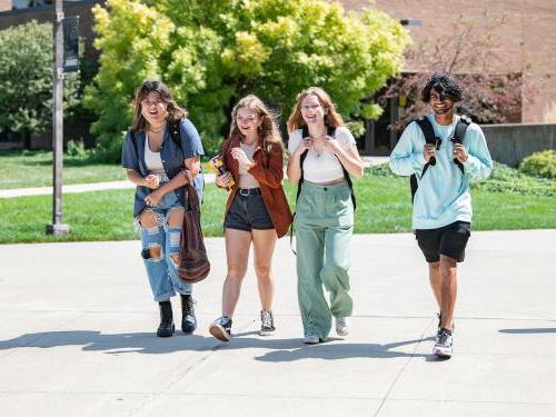 Students walk across campus together.